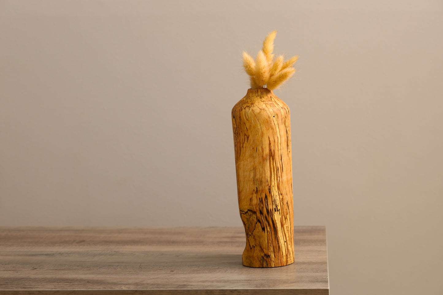 Wood turned spalted maple dry floral vase with a unique divot on the lower half.