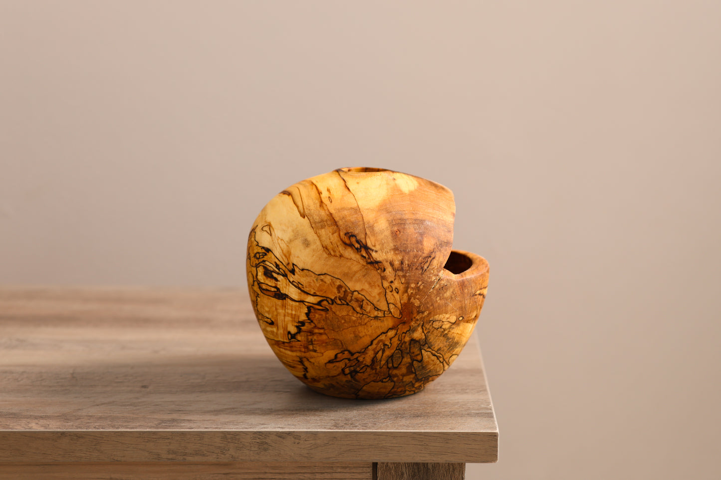 Wood turned spalted maple hollow form, with a gap left from natural tree damage.