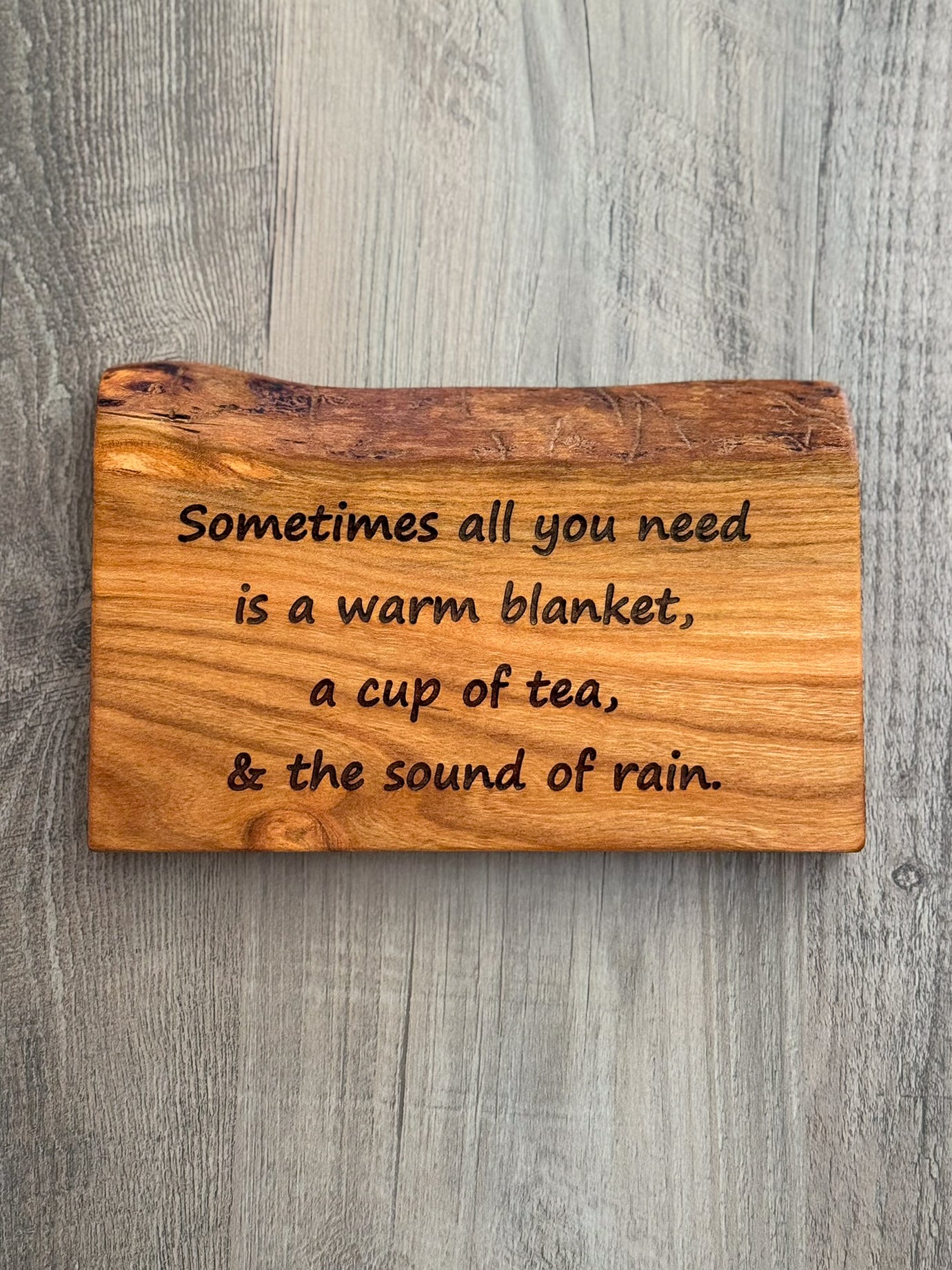 Cherry Wood sign with laser engraved quote "Sometimes all you need is a warm blanket, a cup of tea, & the sound of rain."